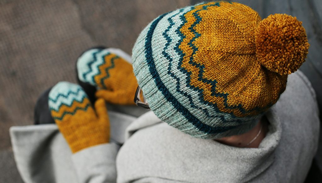 view down upon a person in a colourwork hat and mittens